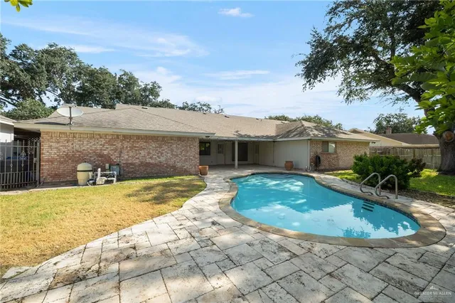 a view of a house with swimming pool and sitting area