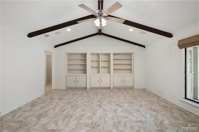 a view of an empty room with a ceiling fan