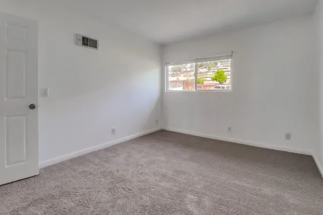 a view of an empty room and a window
