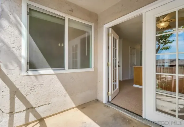 an entryway with wooden floor and windows