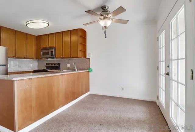 a kitchen with stainless steel appliances granite countertop a refrigerator a stove a sink and dishwasher