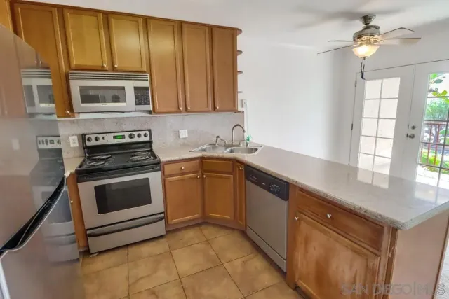 a kitchen with stainless steel appliances a stove sink and microwave