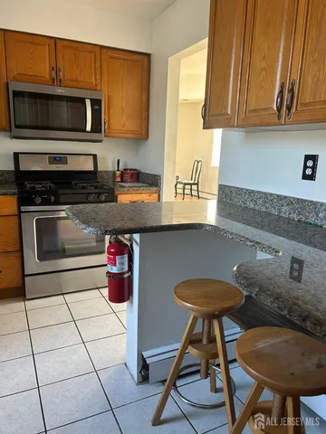 a kitchen with stainless steel appliances a stove a sink and a microwave