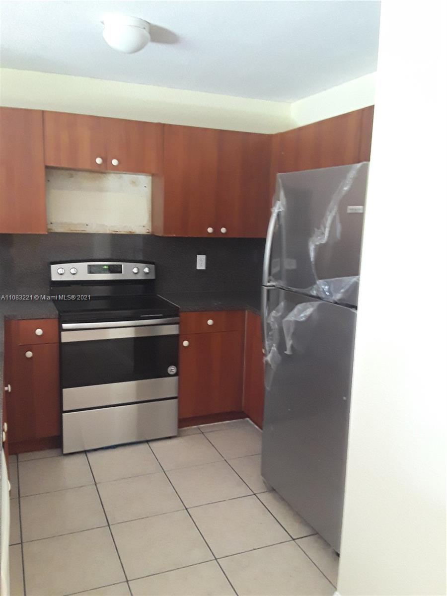 West Perrine Miami, FL 33157 - Photo 3 of 12 a kitchen with a stove and a cabinet