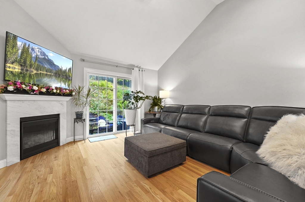 17 Turtle Lane, Unit 17 Sterling, MA 01564 - Photo 11 of 26 a living room with furniture a flat screen tv and a fireplace