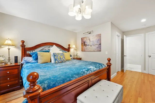 a bedroom with a bed and cabinet