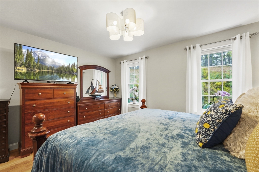 17 Turtle Lane, Unit 17 Sterling, MA 01564 - Photo 14 of 26 a bedroom with a bed and a dresser with mirror