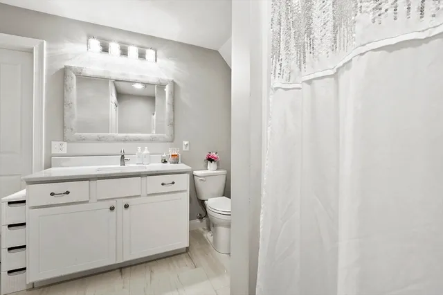 a spacious bathroom with a double vanity sink mirror and toilet