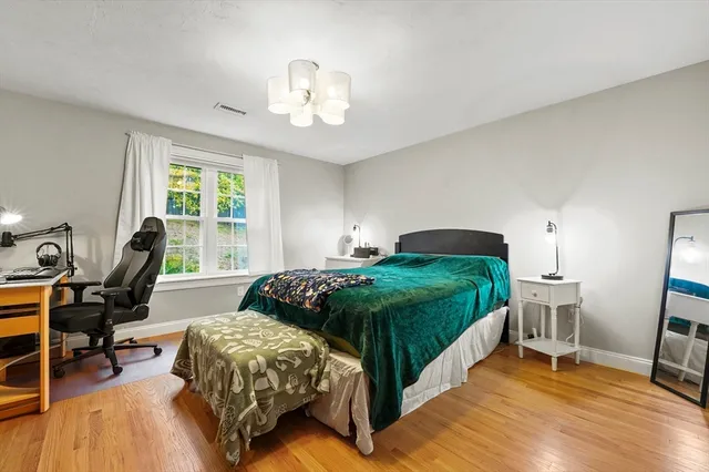 a bedroom with a bed and a chair