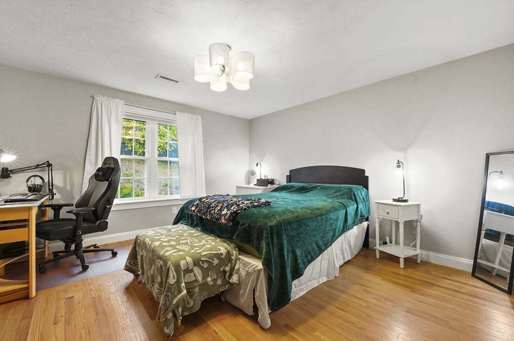 17 Turtle Lane, Unit 17 Sterling, MA 01564 - Photo 19 of 26 a bedroom with a bed and a chair