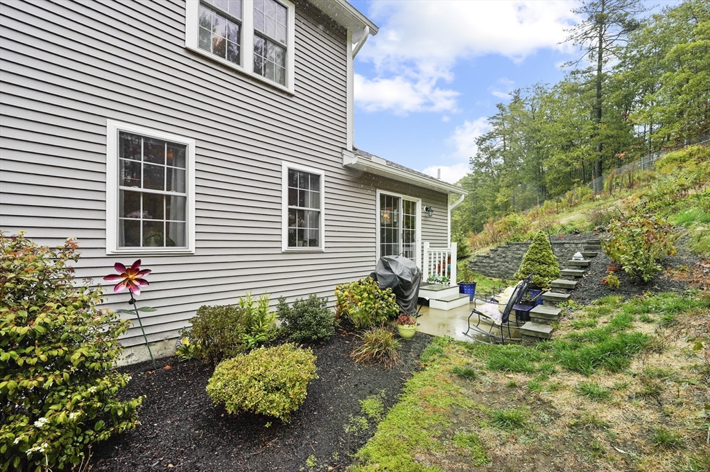 17 Turtle Lane, Unit 17 Sterling, MA 01564 - Photo 22 of 26 a backyard of a house with a garden and outdoor seating