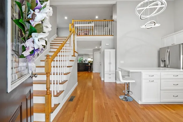 a view of a bedroom with wooden floor and staircase