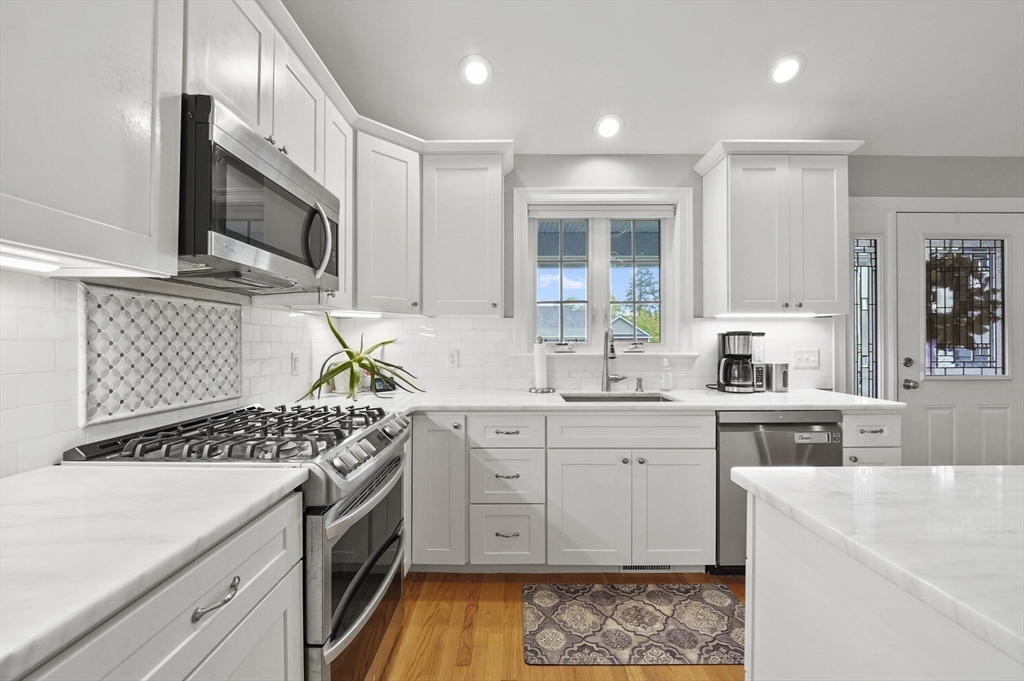 17 Turtle Lane, Unit 17 Sterling, MA 01564 - Photo 6 of 26 a kitchen with stainless steel appliances a stove a sink and a microwave