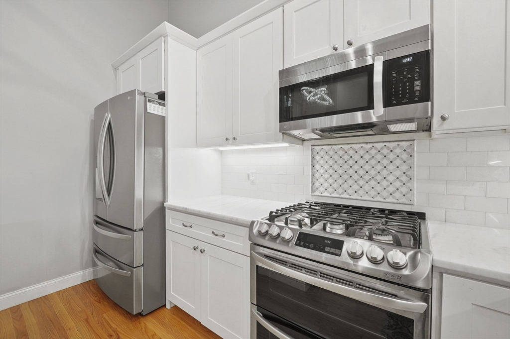 17 Turtle Lane, Unit 17 Sterling, MA 01564 - Photo 8 of 26 a kitchen with stainless steel appliances granite countertop a stove and a microwave