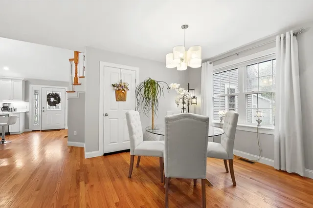 a view of a dining room with furniture wooden floor and chandelier