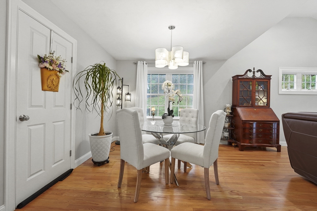 17 Turtle Lane, Unit 17 Sterling, MA 01564 - Photo 10 of 26 a view of a dining room with furniture a chandelier and wooden floor