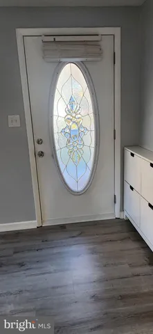 an empty room with a wooden floor and a wooden floor