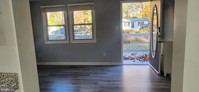 a view of a room with wooden floor and a window