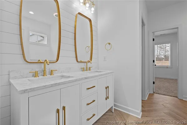 a bathroom with a double vanity sink and a mirror