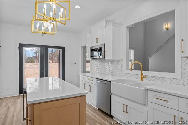 a kitchen with cabinets appliances and a sink