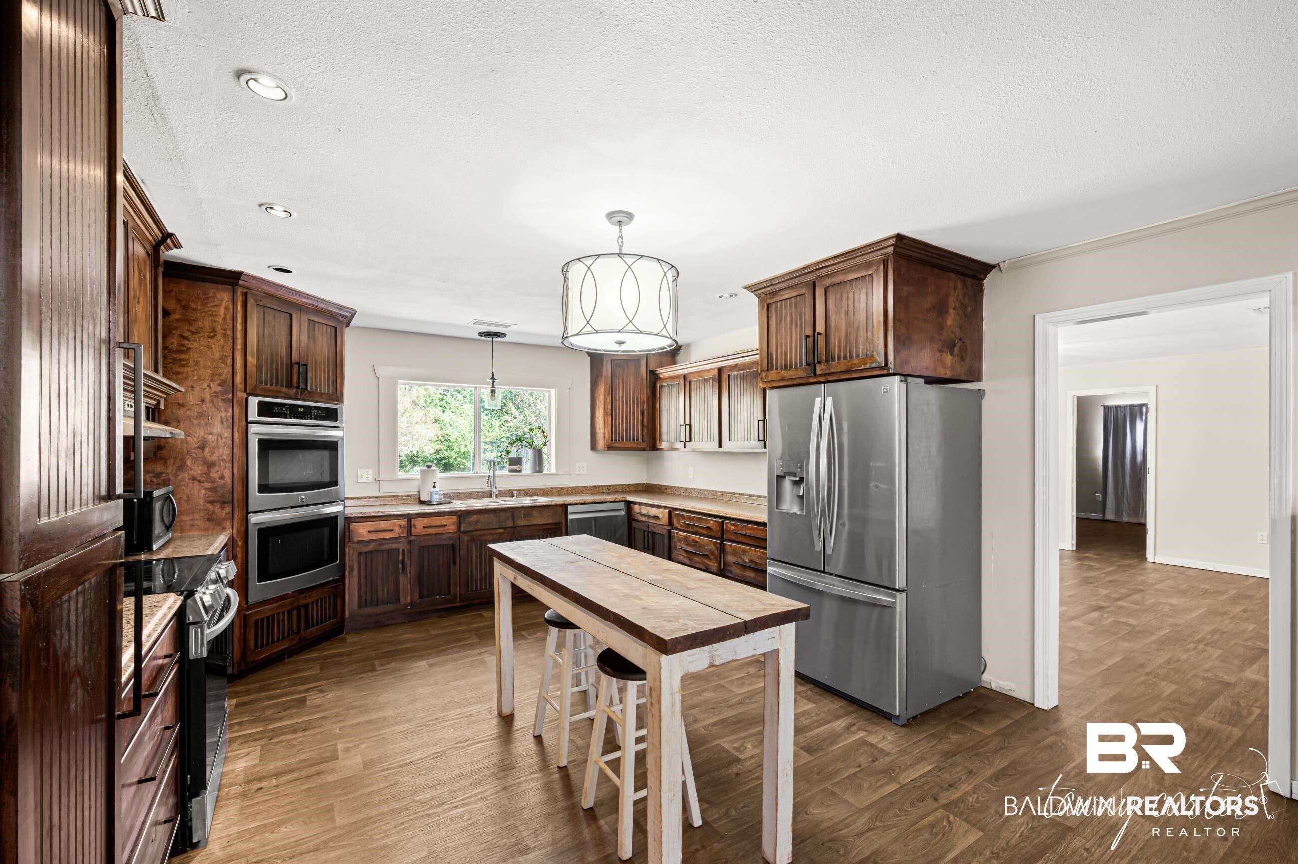 3086 Wild Fork Road Frisco City, AL 36445 - Photo 17 of 30 Kitchen with appliances with stainless steel finishes, hanging light fixtures, dark wood-type flooring, dark brown cabinets, and recessed lighting