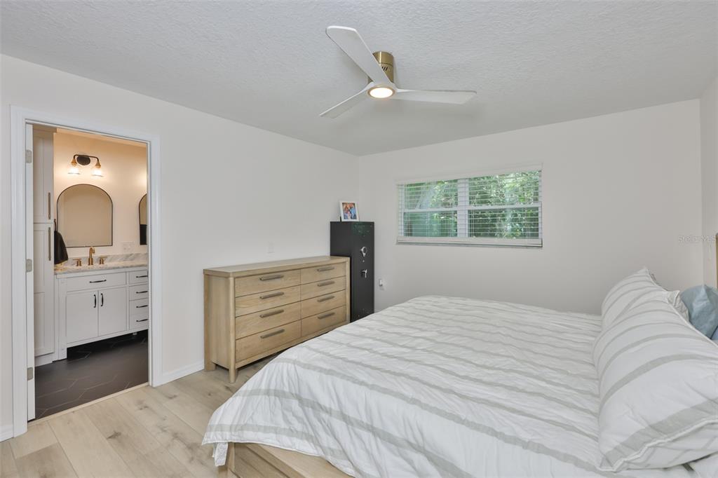 1578 Indian Bay Road Spring Hill, FL 34607 - Photo 24 of 51 a bedroom with a bed and a dresser