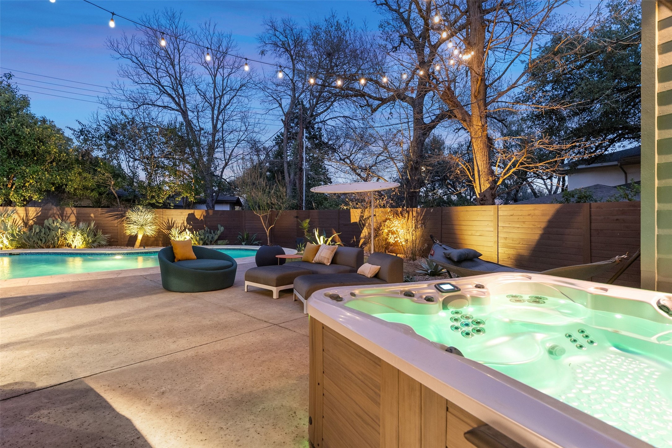 3302 Cherry Tree Circle Austin, TX 78731 - Photo 37 of 39 Fenced backyard with a hot tub and a patio
