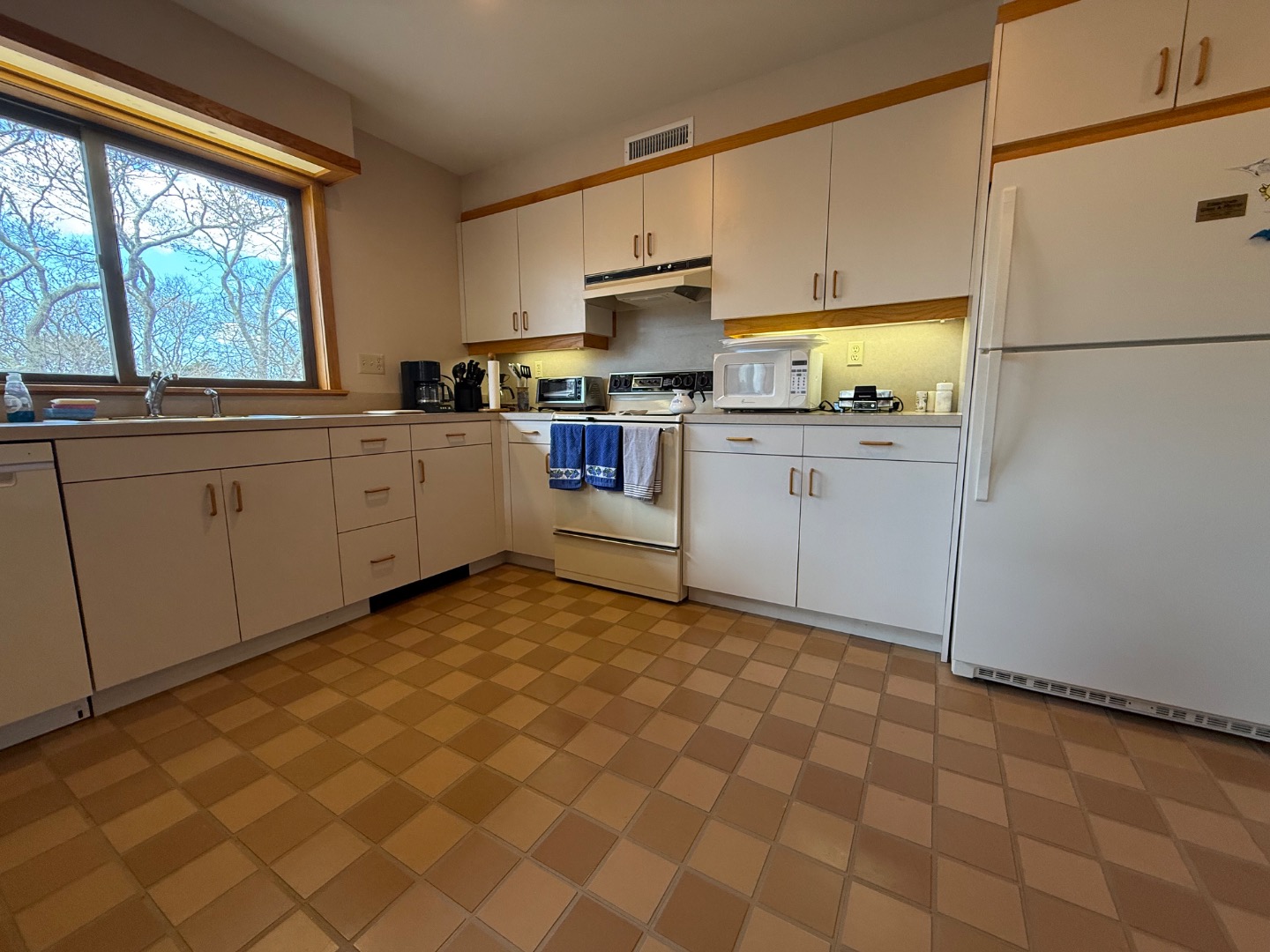 82 Oyster Pond Road Edgartown, MA 02539 - Photo 49 of 53 a kitchen with a cabinets appliances and a window