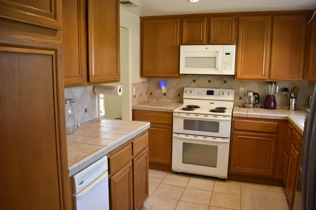 a kitchen with a refrigerator and a sink