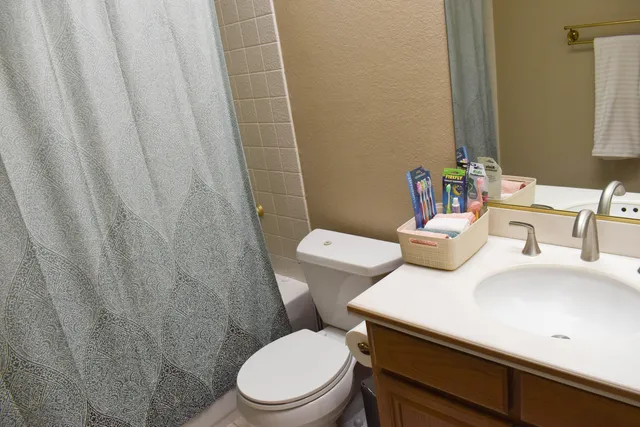 a white bath tub sitting next to a white toilet and sink