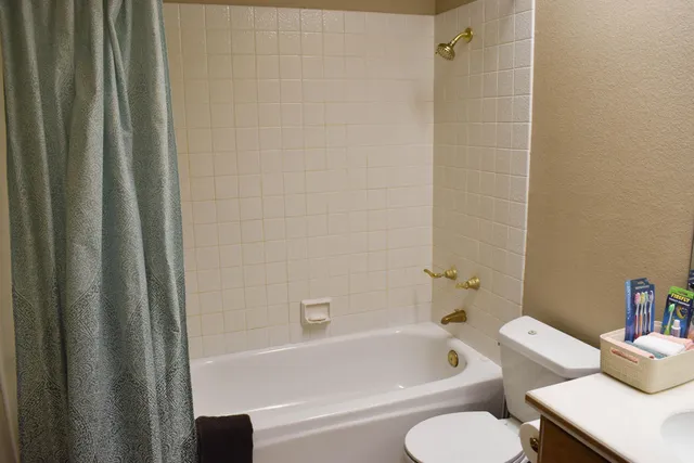 a bedroom with a bed couch and window