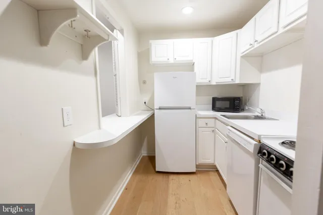 a kitchen with a stove and a refrigerator