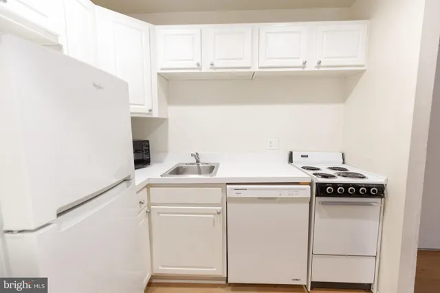 a kitchen with a stove and a white cabinet