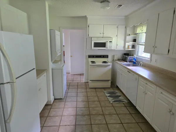 a kitchen with stainless steel appliances a refrigerator sink and microwave