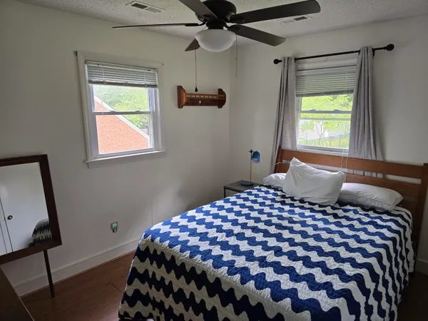 a bedroom with a large bed and a window