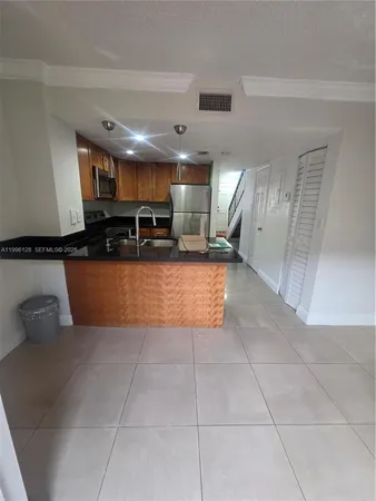 a kitchen with a sink a counter top space and cabinets