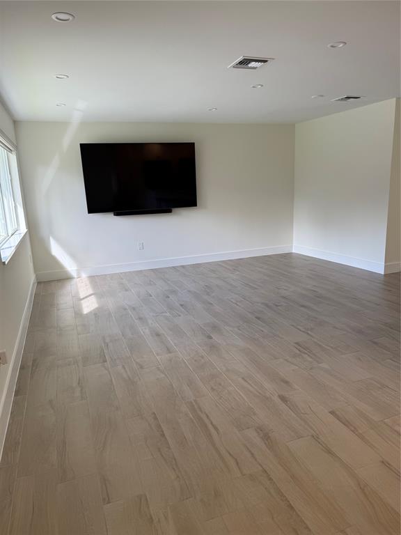1269 Northwest 4th Street Boca Raton, FL 33486 - Photo 11 of 35 a view of an empty room with wooden floor and cabinet