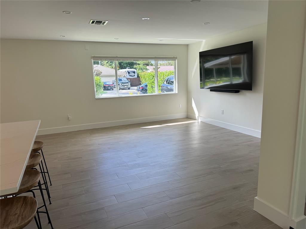 1269 Northwest 4th Street Boca Raton, FL 33486 - Photo 13 of 35 an empty room with wooden floor and windows
