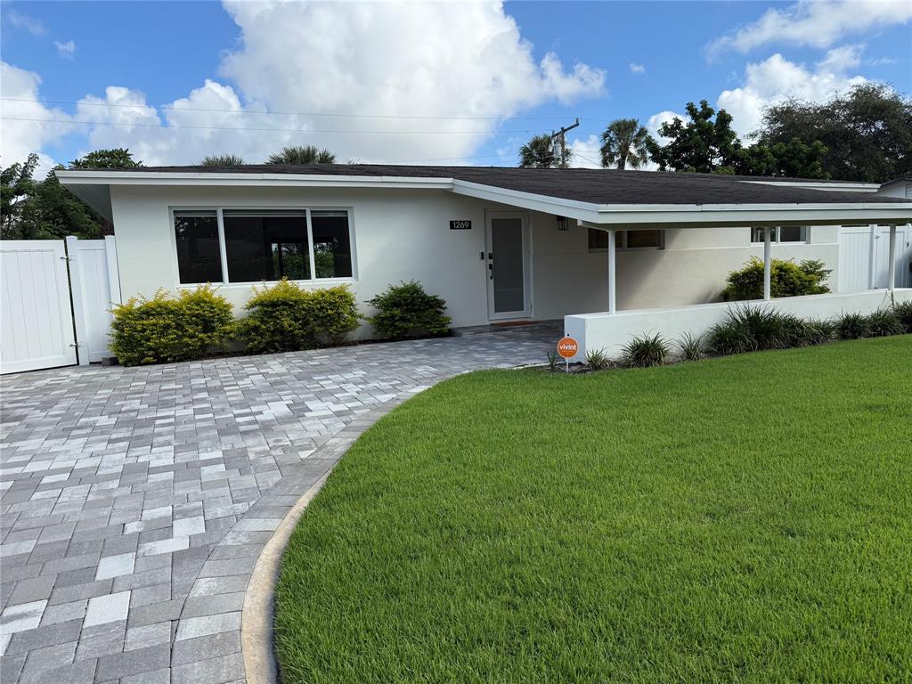1269 Northwest 4th Street Boca Raton, FL 33486 - Photo 23 of 35 a front view of house with yard and green space