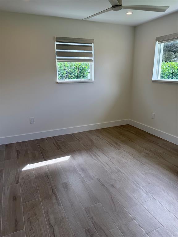 1269 Northwest 4th Street Boca Raton, FL 33486 - Photo 24 of 35 an empty room with wooden floor and windows