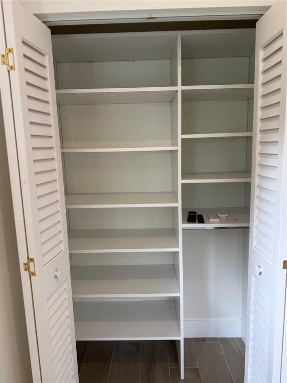 1269 Northwest 4th Street Boca Raton, FL 33486 - Photo 25 of 35 a view of walk in closet with empty racks