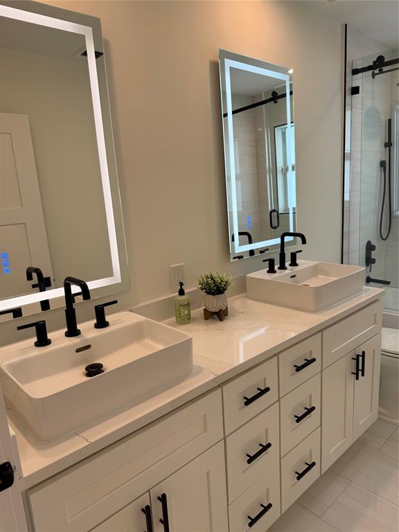 1269 Northwest 4th Street Boca Raton, FL 33486 - Photo 29 of 35 a bathroom with a double vanity sink and mirror
