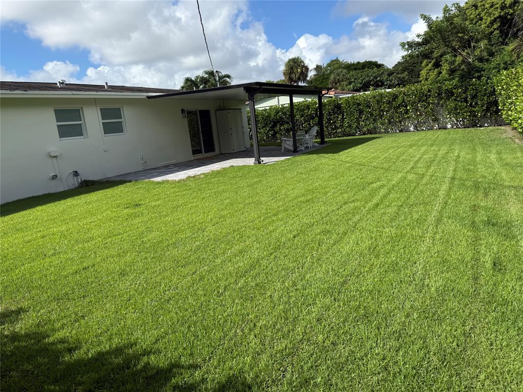 1269 Northwest 4th Street Boca Raton, FL 33486 - Photo 31 of 35 a view of a backyard with table and chairs a barbeque and potted plants