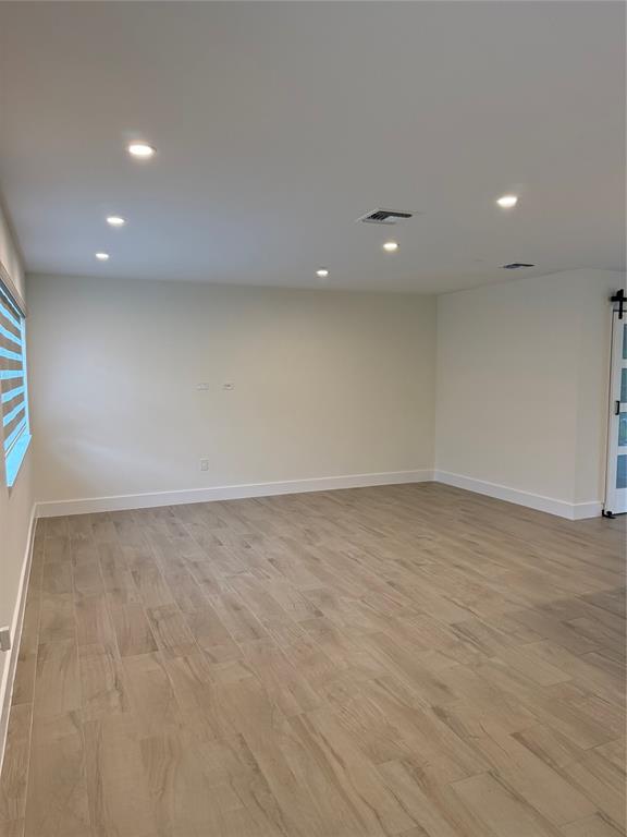 1269 Northwest 4th Street Boca Raton, FL 33486 - Photo 6 of 35 an empty room with wooden floor and natural light