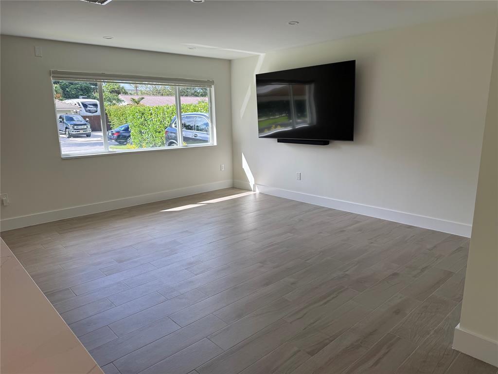 1269 Northwest 4th Street Boca Raton, FL 33486 - Photo 7 of 35 an empty room with windows and fireplace