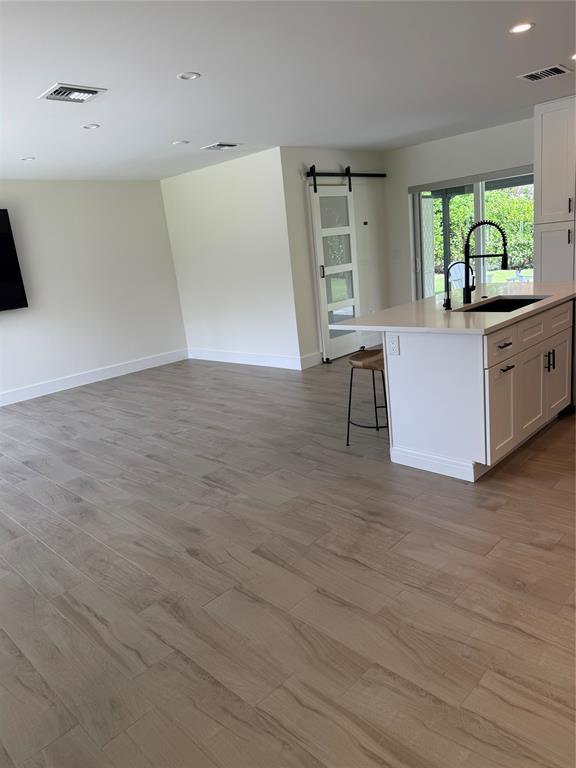 1269 Northwest 4th Street Boca Raton, FL 33486 - Photo 9 of 35 a kitchen view with wooden floor and outdoor space
