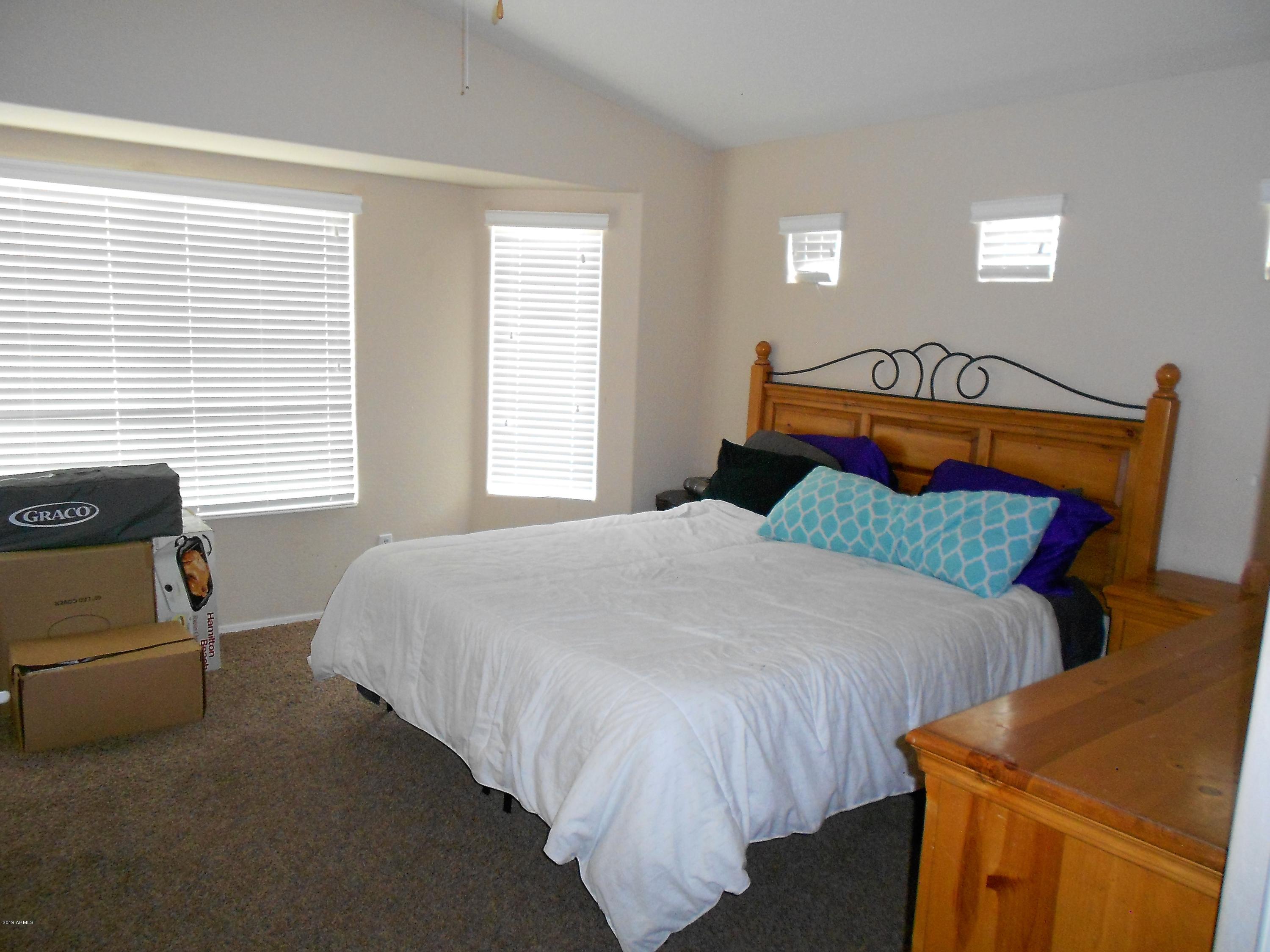 17466 West Boca Raton Road Surprise, AZ 85388 - Photo 9 of 16 a bedroom with a bed and window