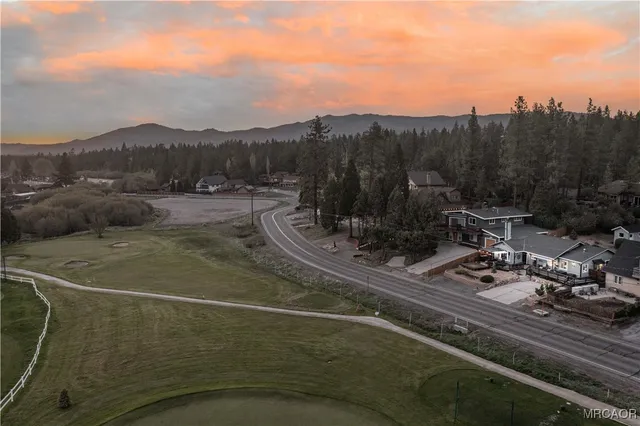 an aerial view of a houses with a swimming pool