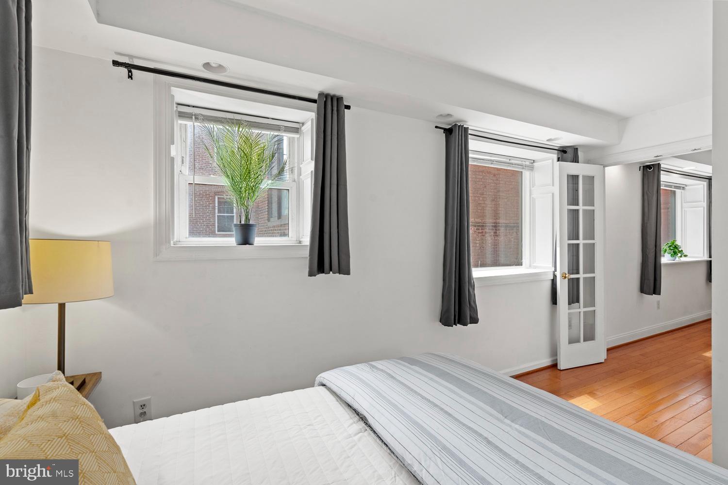 1125 12th Street Northwest, Unit 21 Washington, DC 20005 - Photo 13 of 23 a bedroom with a bed and a window