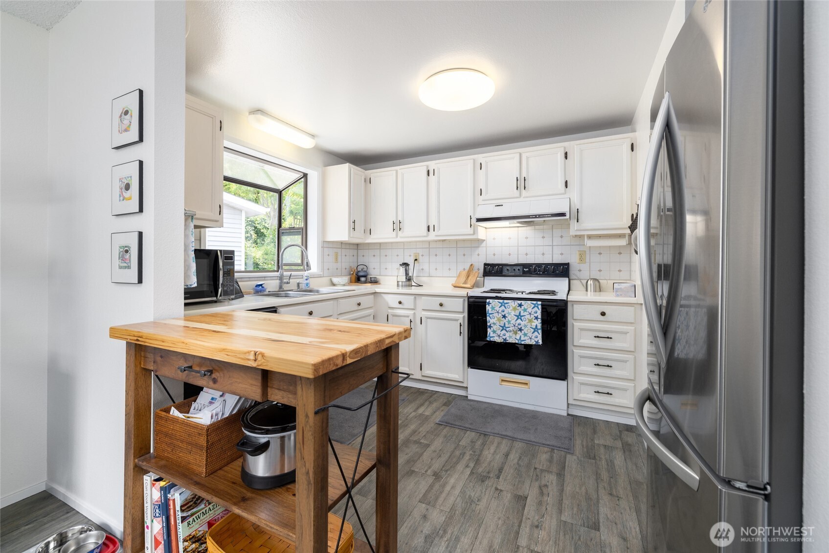 494 Colville Way La Conner, WA 98257 - Photo 13 of 39 a kitchen with stainless steel appliances a stove a sink and a refrigerator